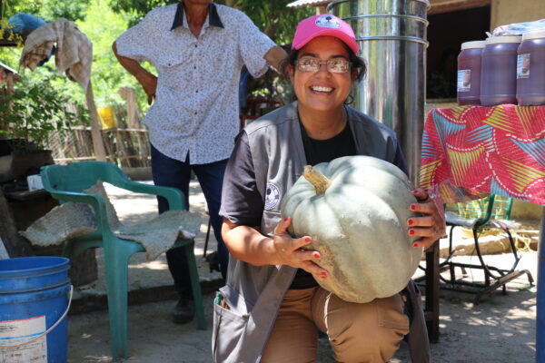 Woman holding pumpkin in Paraguay