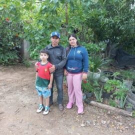 Wilfredo, Aleyda and their son stand together